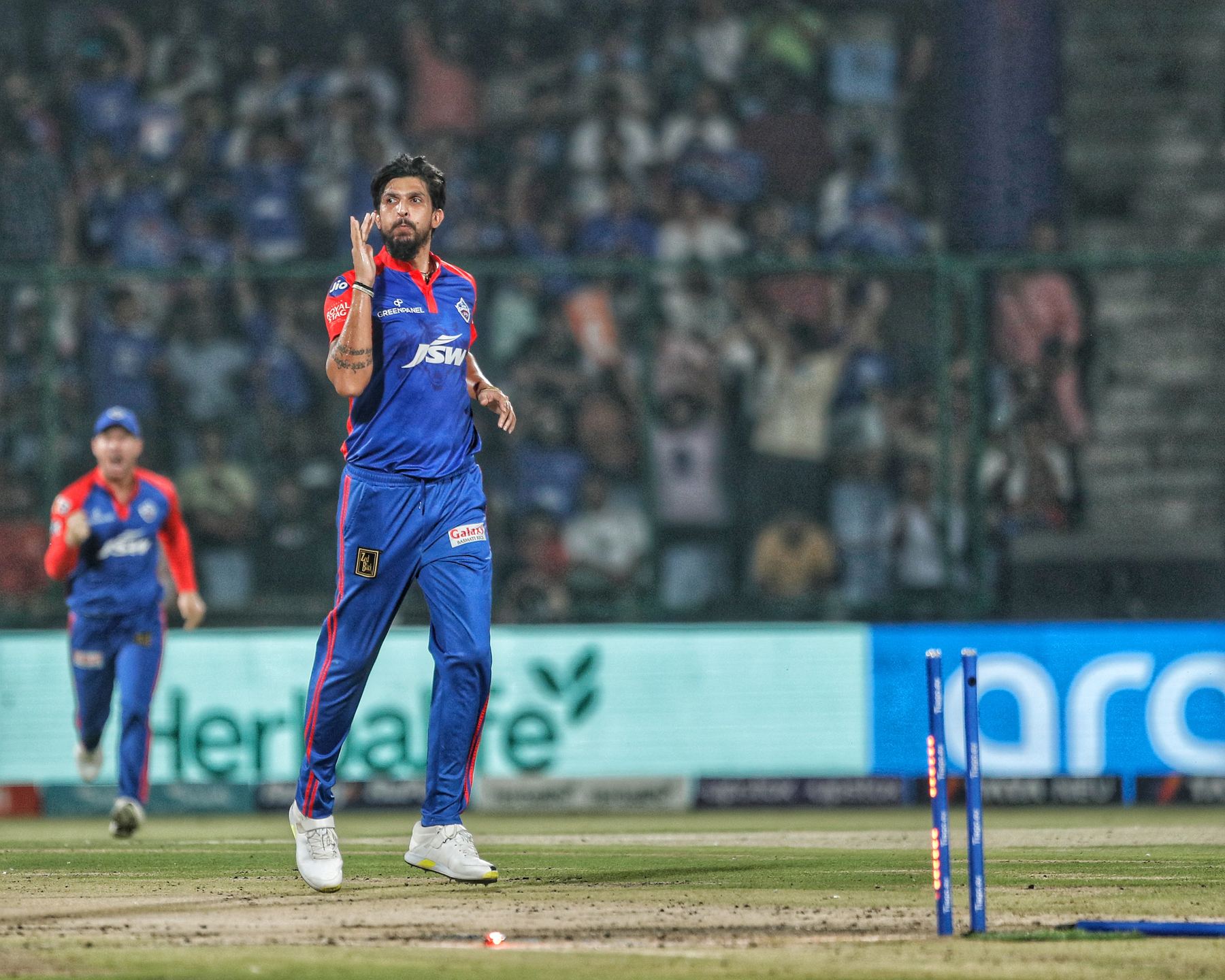 Ishant Sharma celebrating a wicket under stadium lights