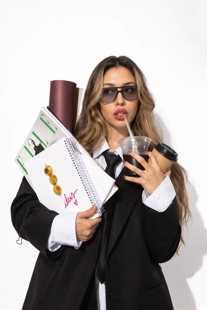 Carrying the week's ideas &mdash; an armful of magazines, a notebook and two coffees