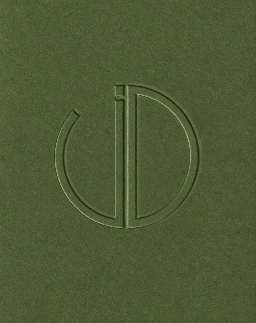 Blind-embossed JD monogram on green board