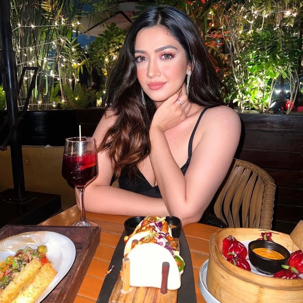 A creator at dinner, with cocktails and plates on the table