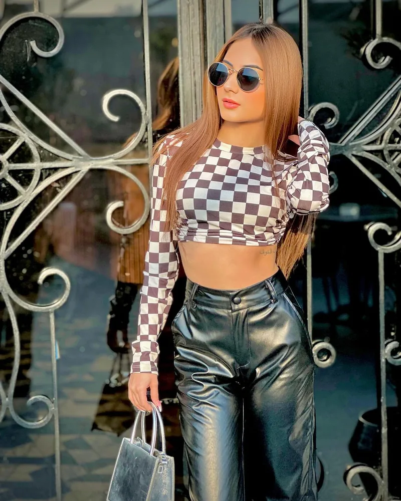 A creator in sunglasses at an iron gate